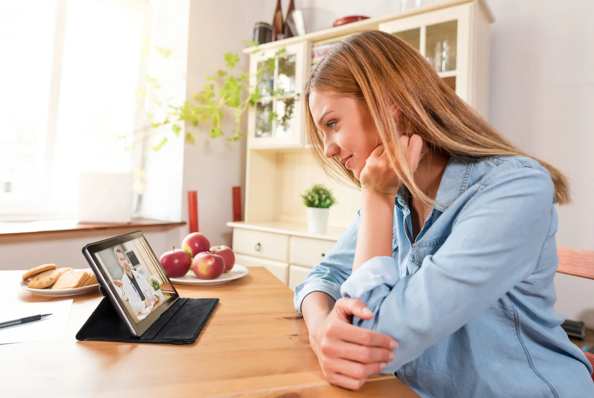Woman in telehealth session with provider